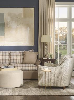 Room Scene: HC9509-S1 Jules Mid Sofa -(AR4) Key Arm, (B5) Wood Trim Base, 
(BX) Box Border shown in 235-82 body/throw pillow fabric with Back/Seat cushion in HC451-84 fabric and Natural nail trim and Java finish, HC9509-CH - (AR5) Flare Arm, (PC) Pleat Corner Welt, 
(B2) Tapered Leg Base shown in HC470-86 fabric with HC3118-88 welt and Java finish, HC130-30 Saturn Round Ottoman shown in HC470-86 fabric and HC4751-51 Tessa M2M End Table shown in Tortoise finish.
